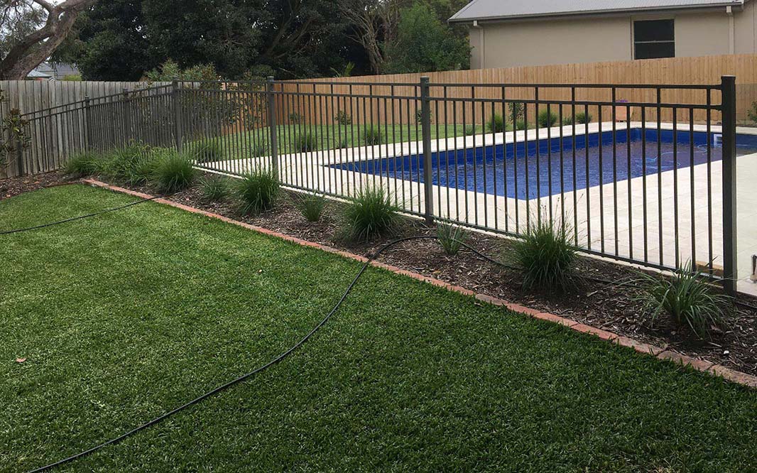 Backyard with pool and aluminum fencing