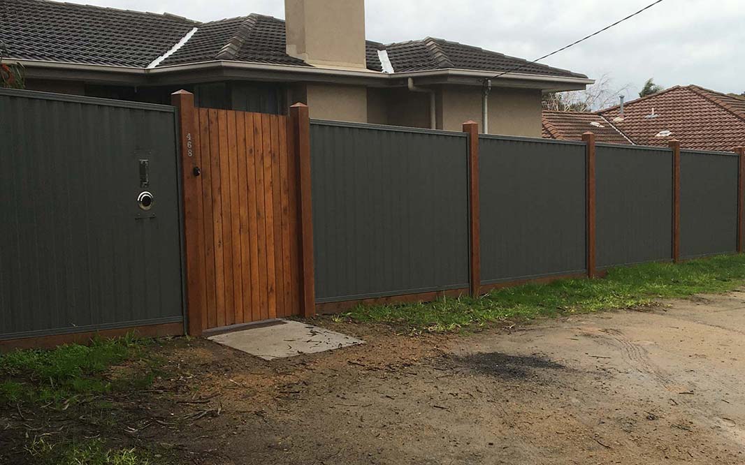 Colorbond front fence with wooden gate and posts